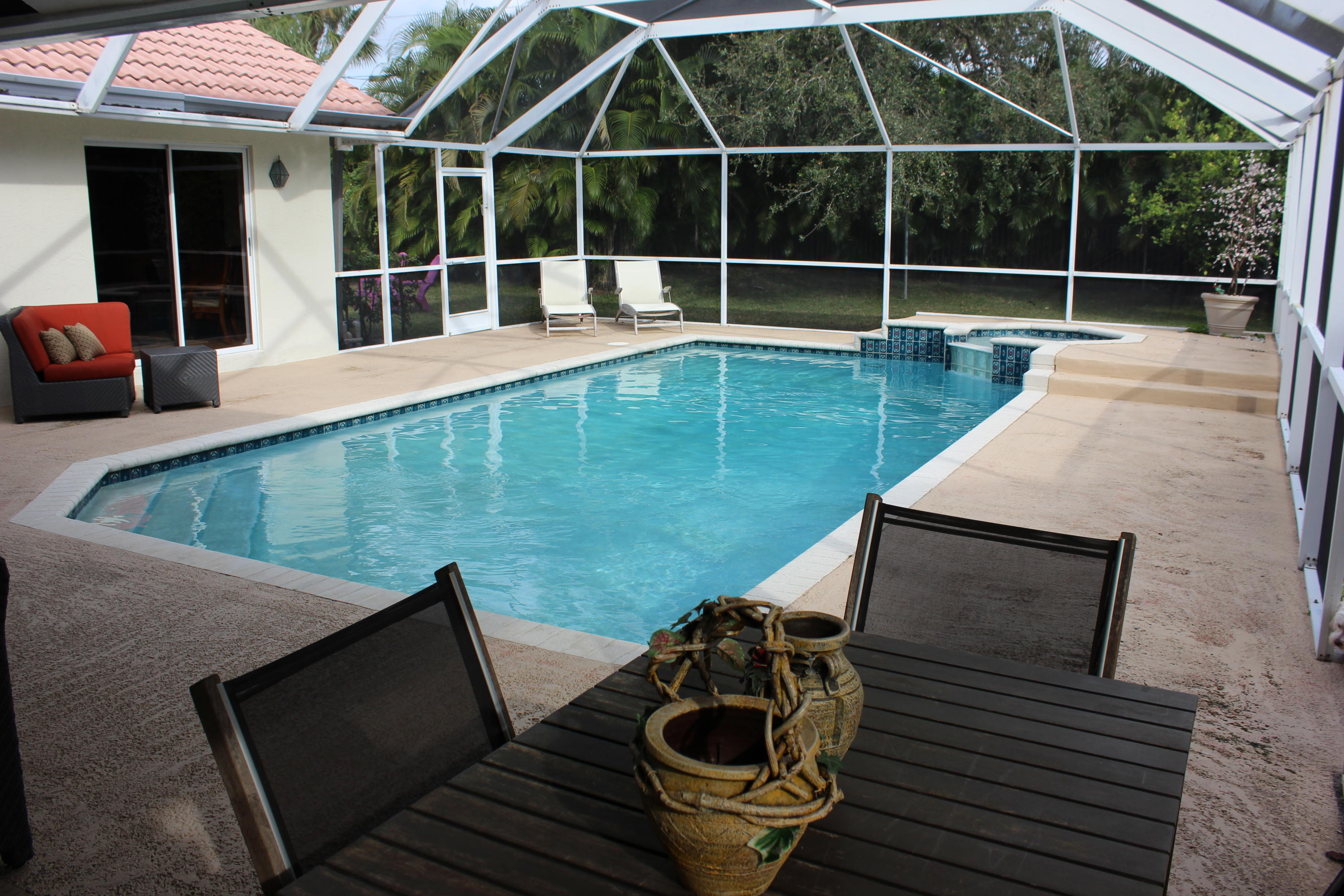 2671 Northwest 49th Street Boca Raton, FL 33434 - Photo 8 of 47 a view of a backyard with table and chairs and wooden floor