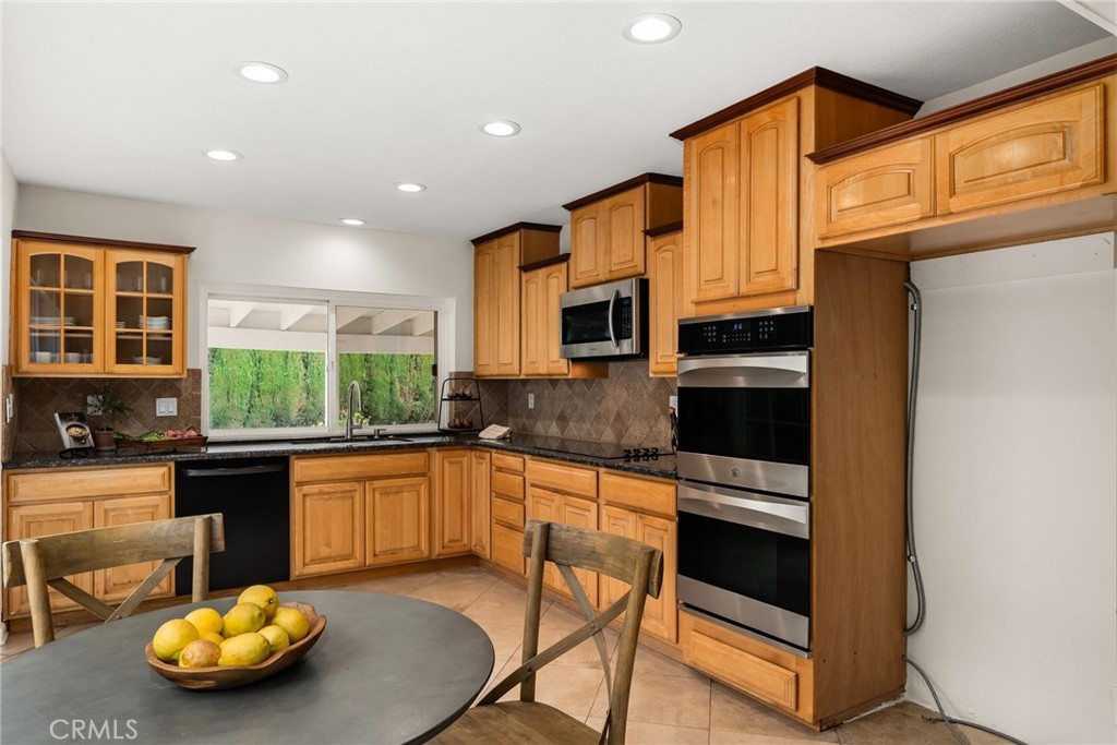 1902 East Eucalyptus Lane Brea, CA 92821 - Photo 8 of 41 a kitchen with stainless steel appliances granite countertop a stove a sink and a microwave