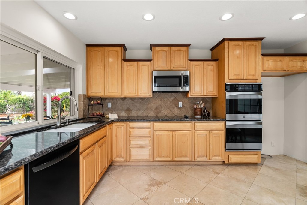 1902 East Eucalyptus Lane Brea, CA 92821 - Photo 9 of 41 a kitchen with stainless steel appliances a sink stove and cabinets