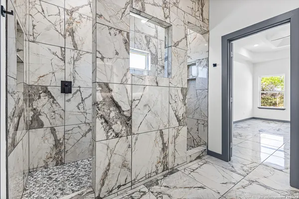 a bath room with sink and mirror