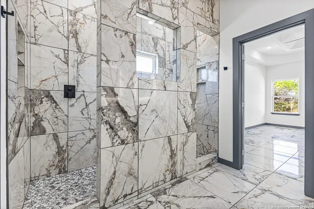 a bath room with sink and mirror
