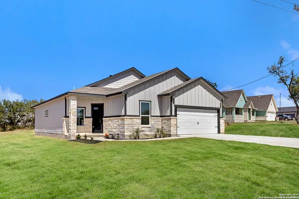 a front view of house with yard and green space
