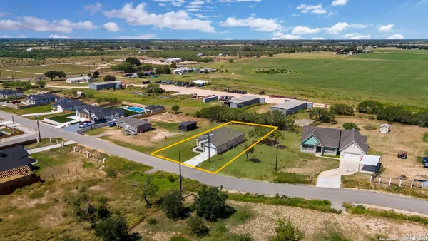 an aerial view of a house with a yard