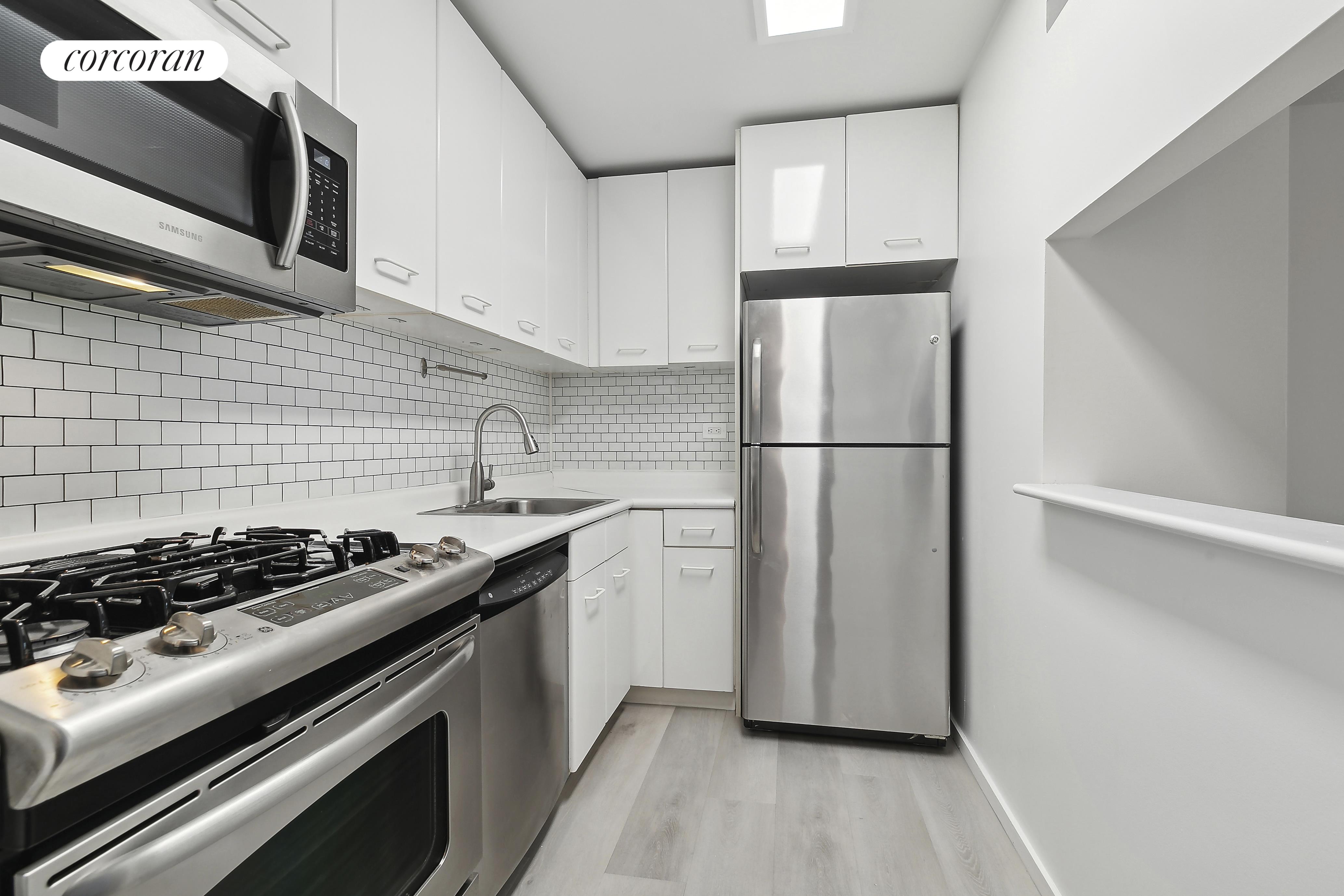 2373 Broadway, Unit 705 Manhattan, NY 10024 - Photo 7 of 13 a kitchen with stainless steel appliances granite countertop a stove and a refrigerator