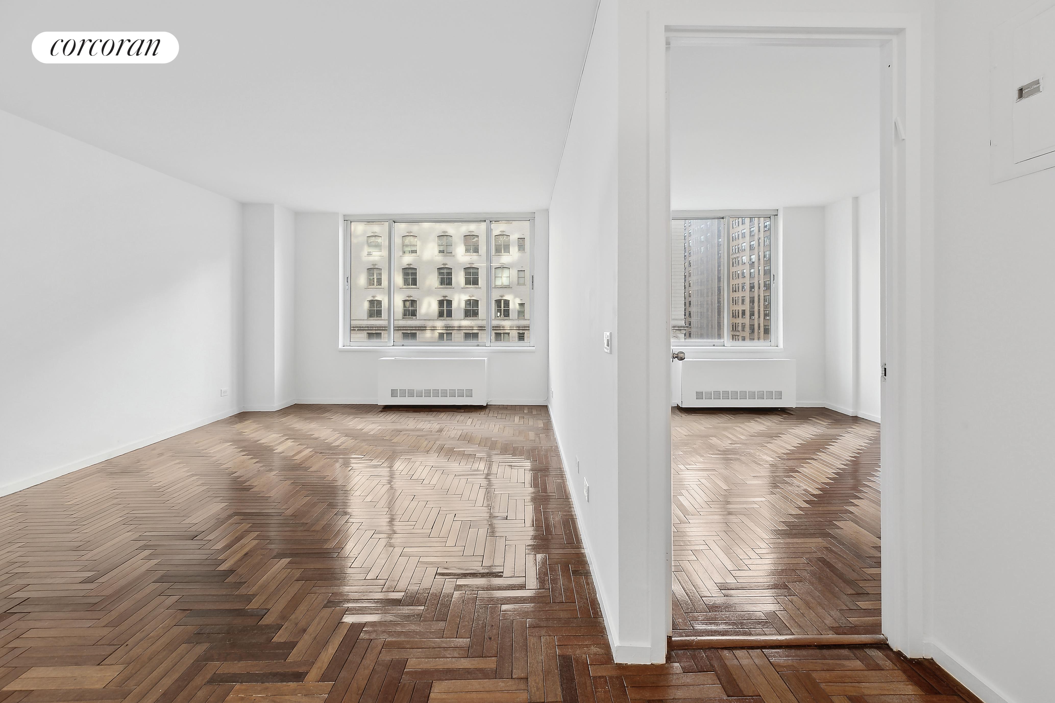 2373 Broadway, Unit 705 Manhattan, NY 10024 - Photo 8 of 13 a view of an empty room with wooden floor and a window