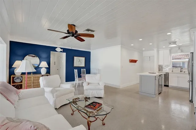 a living room with furniture and kitchen view