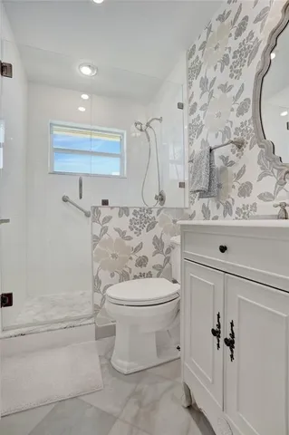 a bathroom with a sink toilet and shower