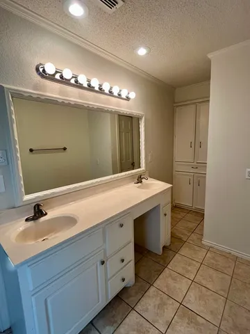 a bathroom with a sink double vanity and a mirror