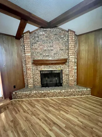 a view of fireplace and wooden floor