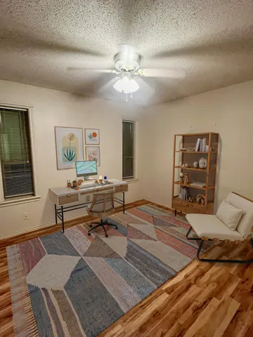 a living room with furniture and a wooden floor