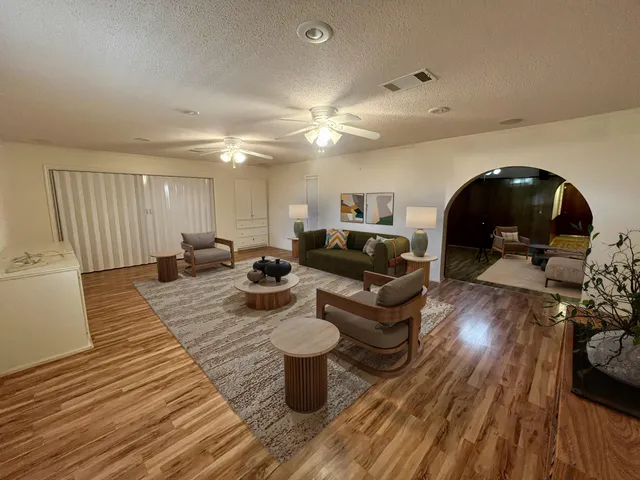 a living room with furniture and a wooden floor