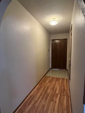 a view of hallway with wooden floor