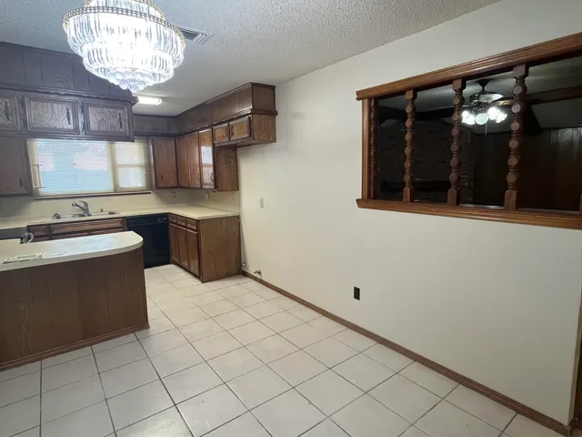 a kitchen with cabinets and window