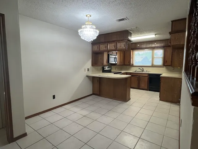 a kitchen with stainless steel appliances granite countertop a sink counter space and cabinets