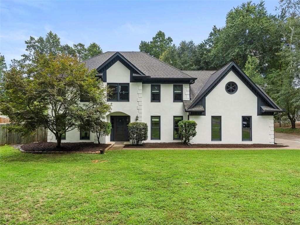 705 Upper Hembree Road Roswell, GA 30076 - Photo 1 of 1 a front view of house with a garden