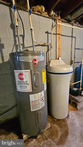 a utility room with a refrigerator and washer