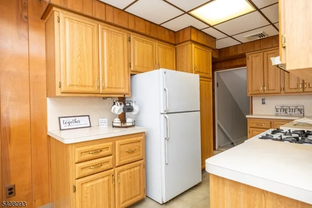 a white refrigerator freezer sitting in a kitchen
