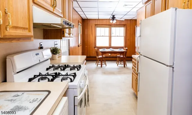 a dining room with furniture and a window