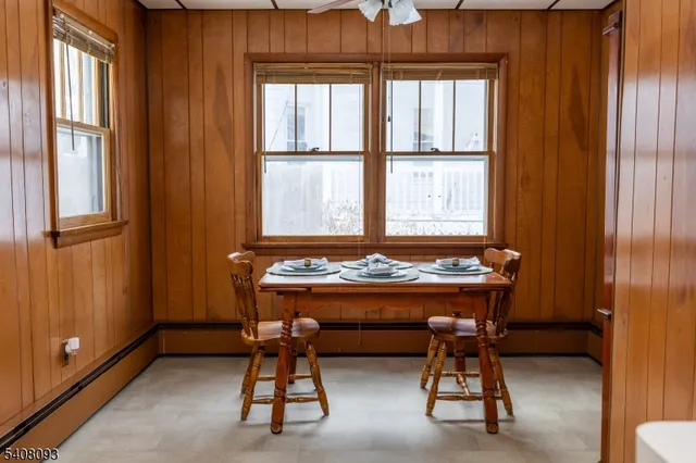 a room with table chair and windows