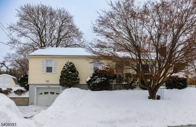 a view of a house with a yard covered in snow