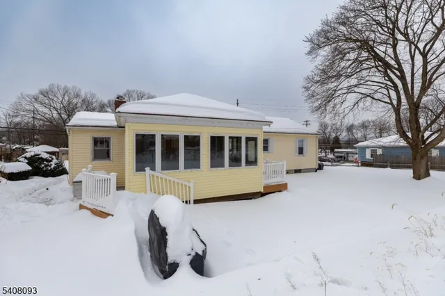 a view of a house with a snow in the yard