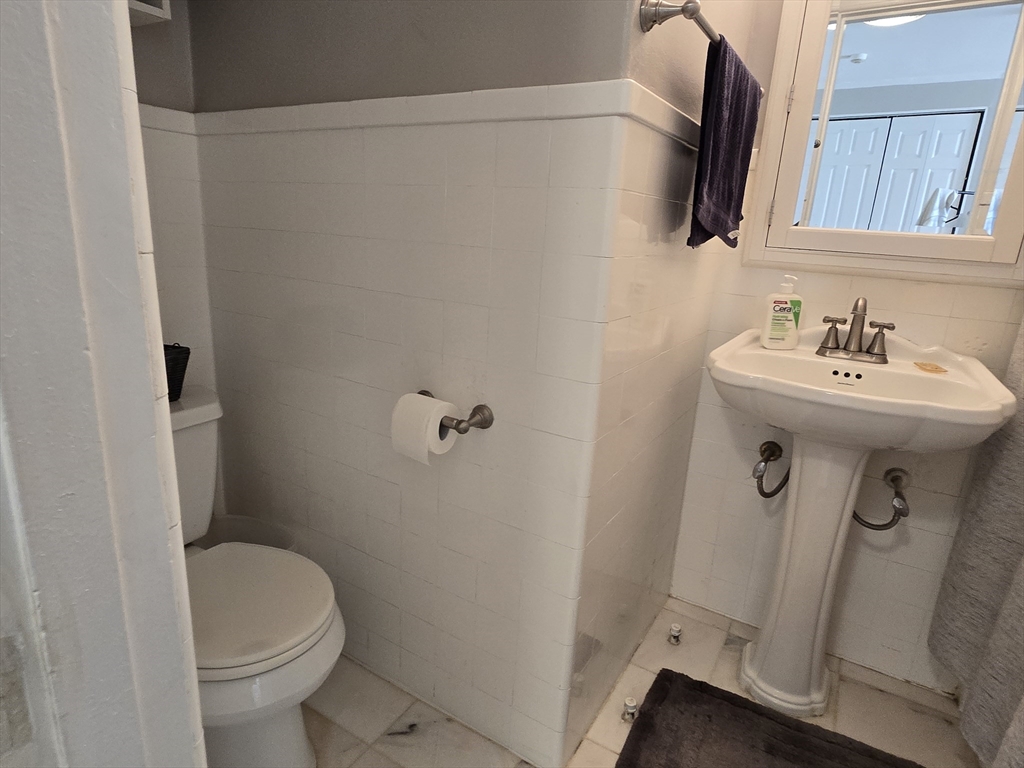 21 Beacon Street, Unit 10C Boston, MA 02108 - Photo 13 of 20 a bathroom with a sink a toilet and mirror