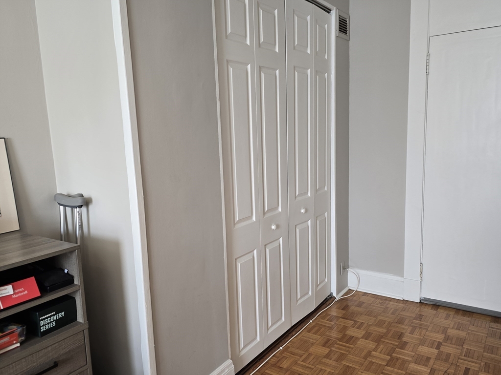21 Beacon Street, Unit 10C Boston, MA 02108 - Photo 5 of 20 a view of a livingroom with wooden floor and closet