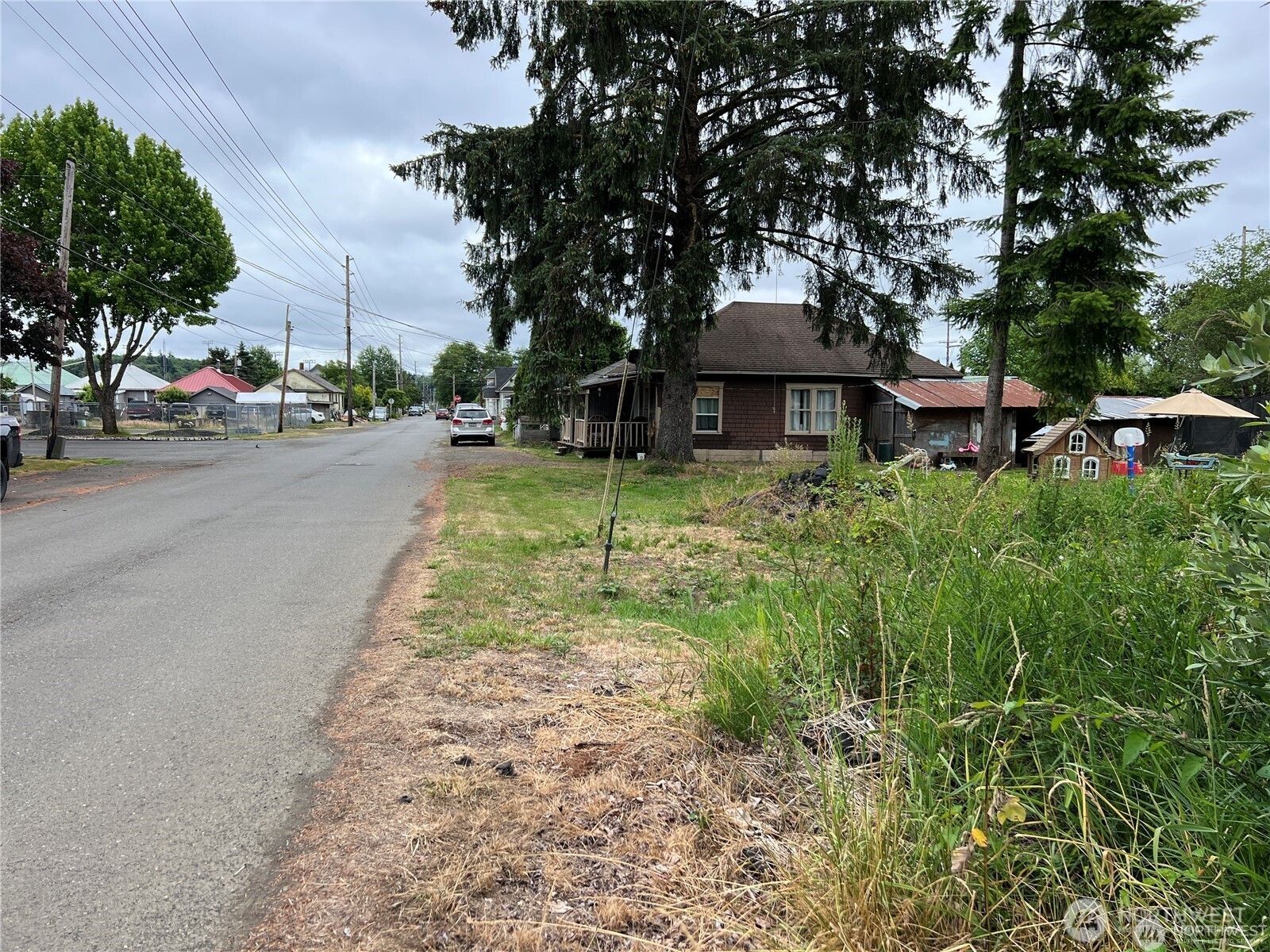 0 X Eight Street Raymond, WA 98577 - Photo 7 of 8 a view of a patio with a table and chairs under an umbrella