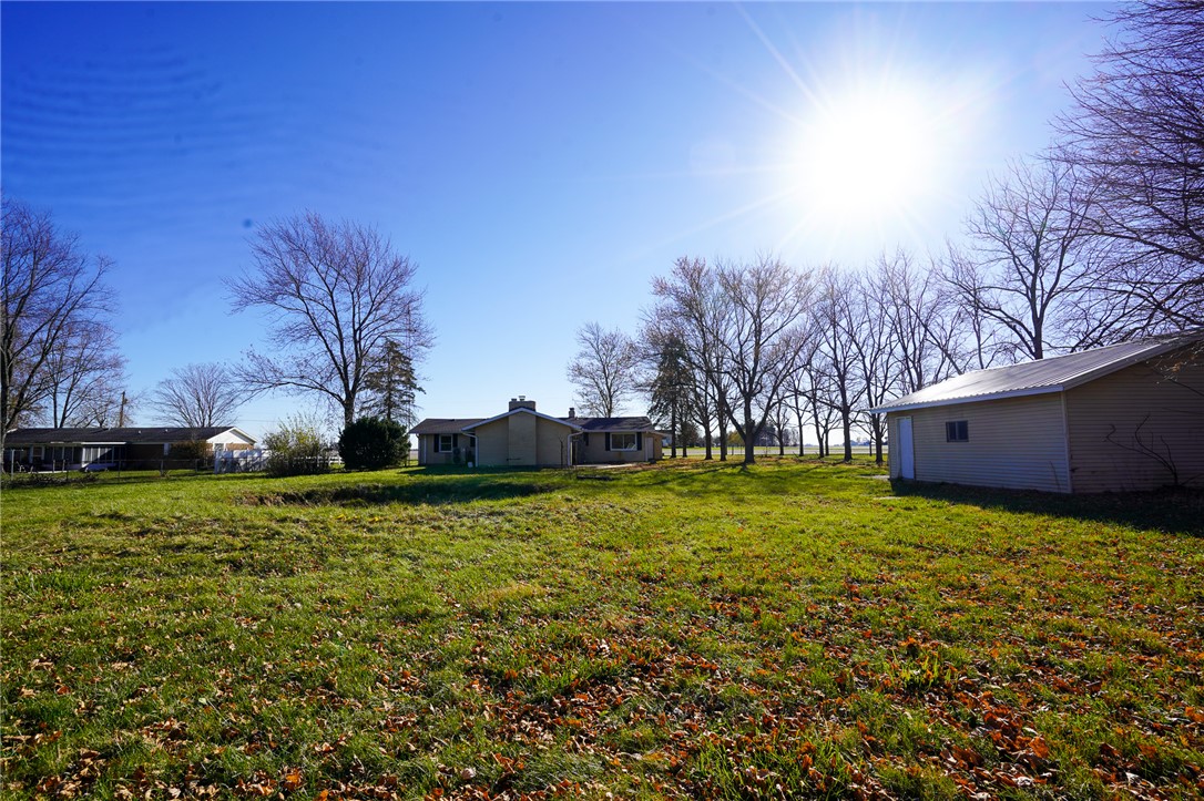 8746 Grubbs-Rex Road Arcanum, OH 45304 - Photo 28 of 38 Expansive outdoor space features a detached storage building and a broad green lawn.