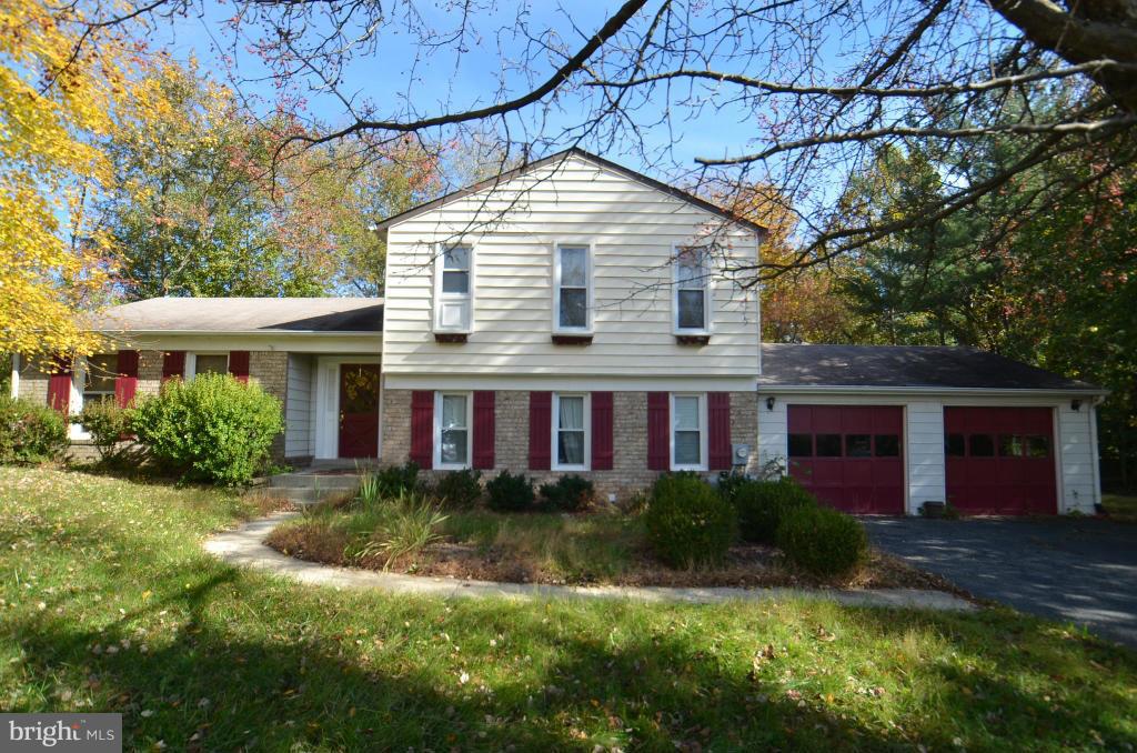 6711 Garrett Road Derwood, MD 20855 - Photo 1 of 21 a front view of a house with garden