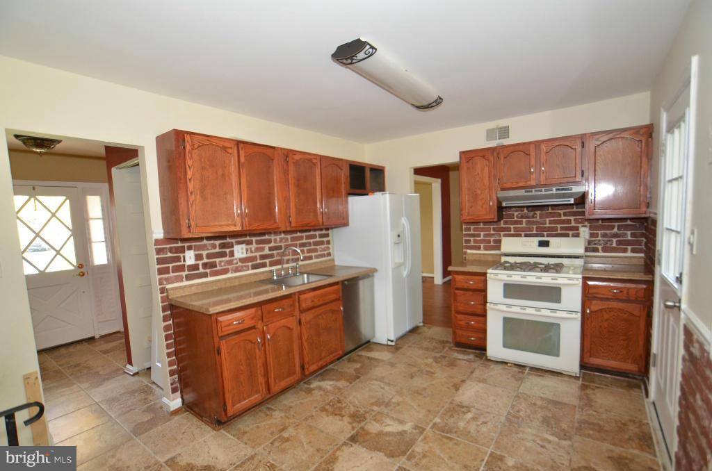 6711 Garrett Road Derwood, MD 20855 - Photo 15 of 21 a kitchen with stainless steel appliances granite countertop a stove and a refrigerator