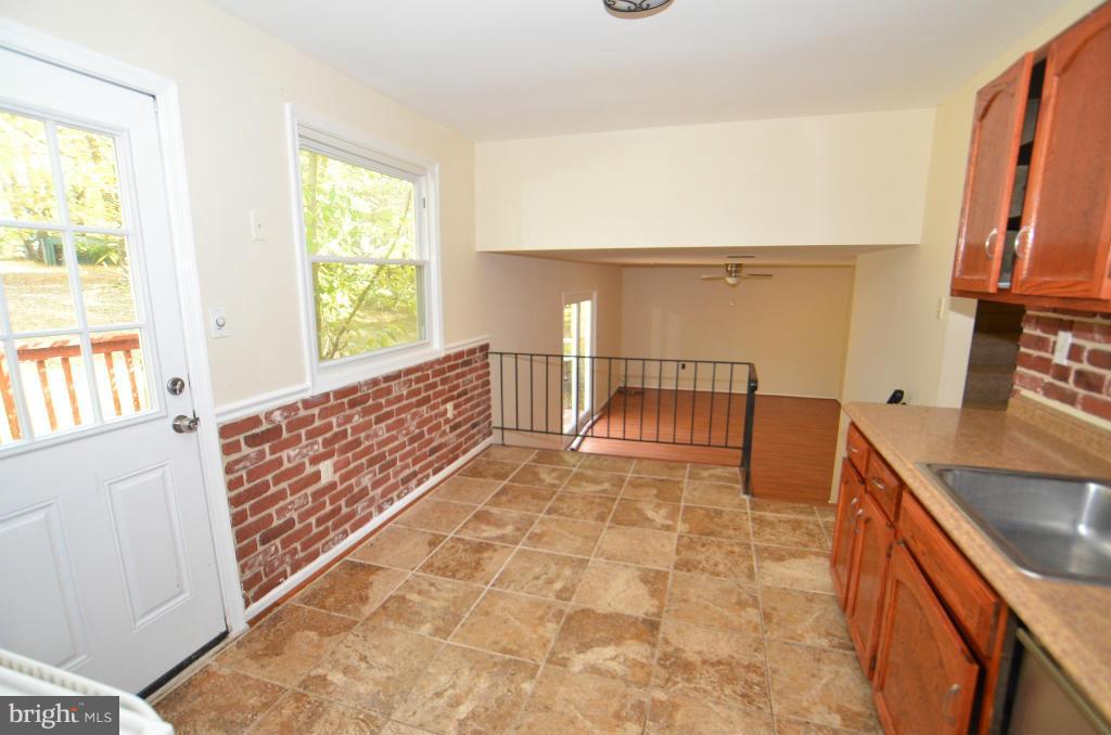6711 Garrett Road Derwood, MD 20855 - Photo 16 of 21 a view of a hallway with wooden floor and a living room