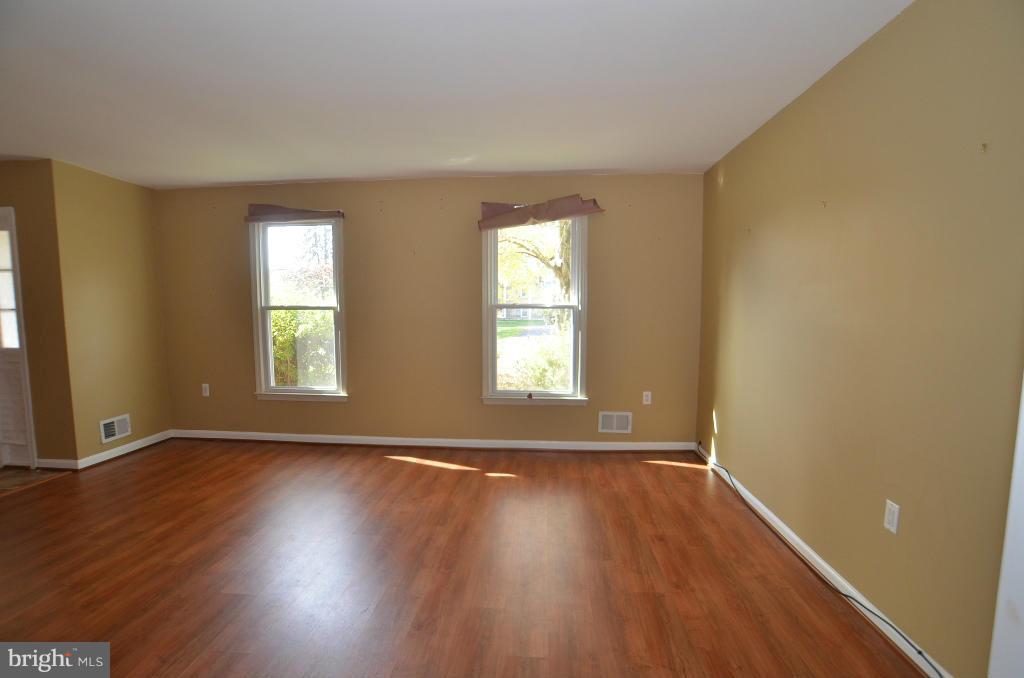 6711 Garrett Road Derwood, MD 20855 - Photo 18 of 21 a view of an empty room with wooden floor and a window