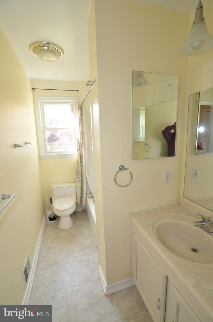 6711 Garrett Road Derwood, MD 20855 - Photo 3 of 21 a bathroom with a sink a toilet and a mirror