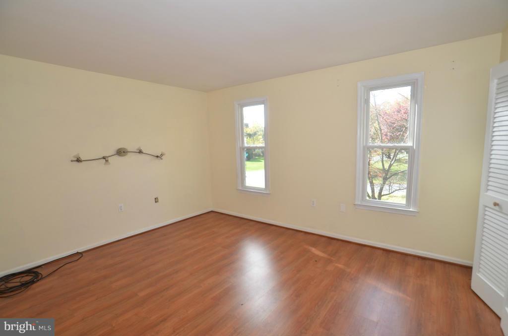6711 Garrett Road Derwood, MD 20855 - Photo 4 of 21 a view of an empty room with wooden floor and a window
