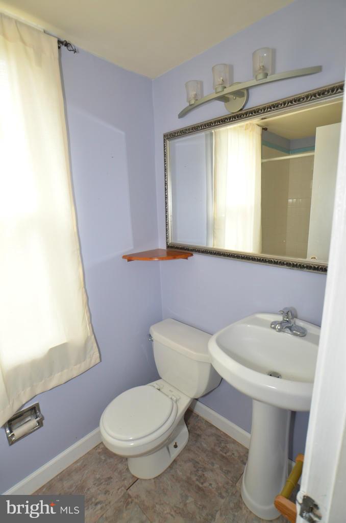 6711 Garrett Road Derwood, MD 20855 - Photo 5 of 21 a white toilet sitting next to a bathroom sink