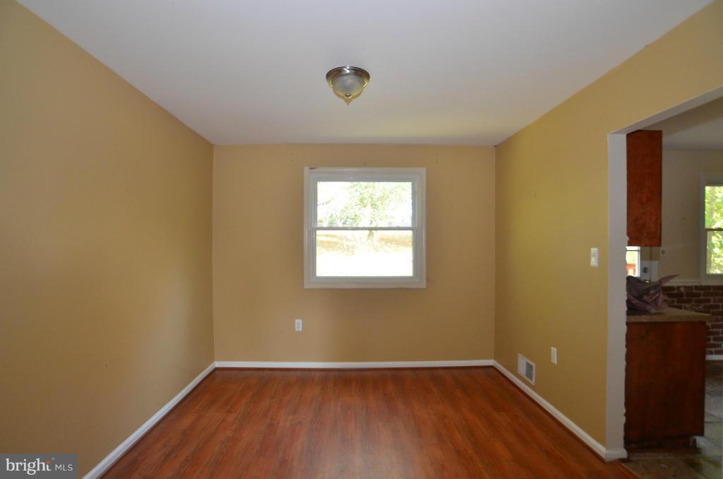 6711 Garrett Road Derwood, MD 20855 - Photo 8 of 21 an empty room with wooden floor and windows