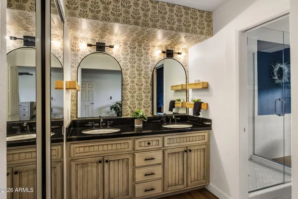 a bathroom with a double vanity sink and a mirror
