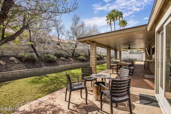 a view of a patio with table and chairs and potted plants