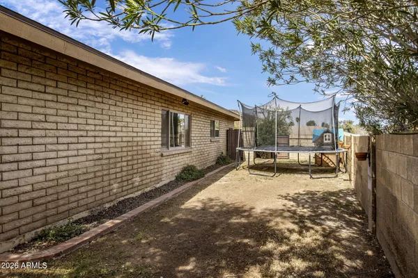a view of a house with a wooden fence