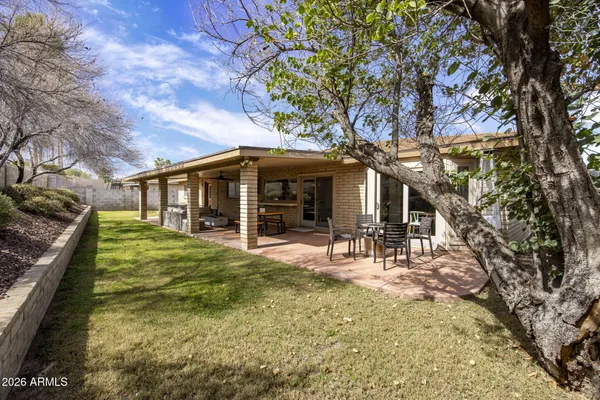 a front view of a house with swimming pool and sitting area