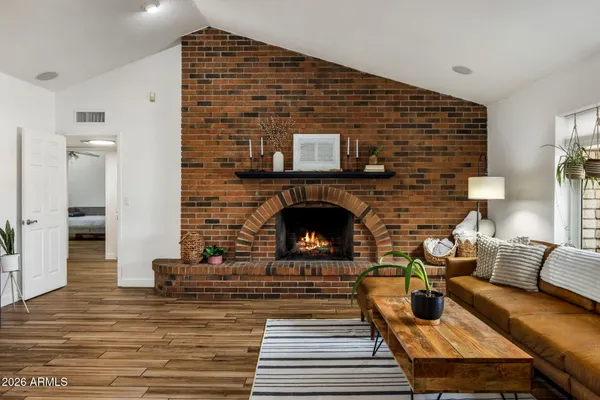 a living room with furniture and a fireplace
