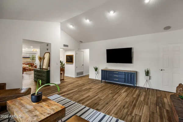 a bedroom with furniture and a flat screen tv
