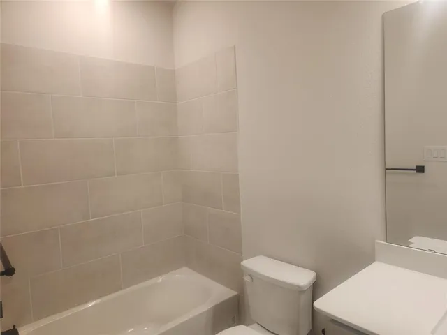 a white bath tub sitting next to a white toilet