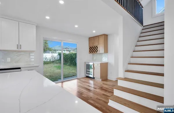 a view of a hallway with wooden floor and entryway
