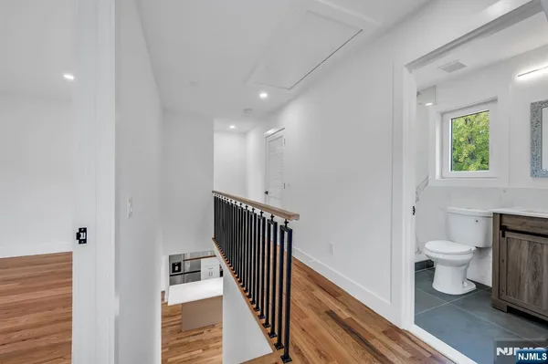 a bathroom with a toilet sink a mirror and shower