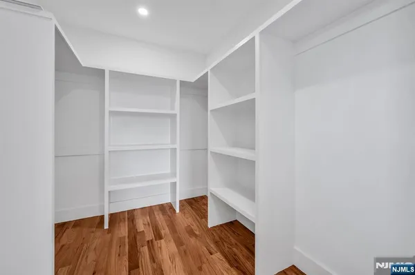 a view of walk in closet with empty racks