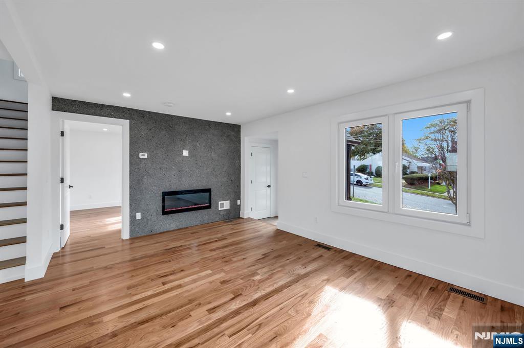 378 Marvin Avenue Hackensack, NJ 07601 - Photo 6 of 46 a view of empty room with wooden floor and fireplace
