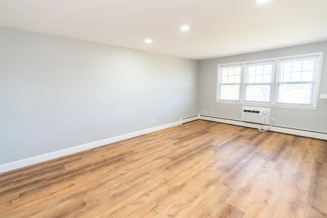 wooden floor in an empty room with a window