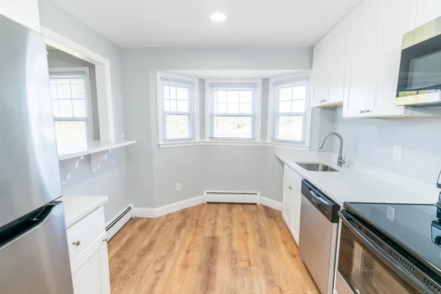 a kitchen with a sink a window and stainless steel appliances